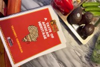 A still from a video shows a recipe book entitled, "A Taste of African Heritage."